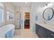 Serene bathroom with soaking tub, glass shower and closet access at 3862 Memphis Dr, Suwanee, GA 30024