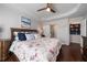 Cozy main bedroom featuring barn door closet, ensuite bath and wood floors at 3862 Memphis Dr, Suwanee, GA 30024