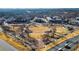 Aerial view of park with seating areas, walkways, and surrounding buildings and neighborhood at 3862 Memphis Dr, Suwanee, GA 30024