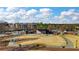 Aerial view of park with outdoor stage, amphitheater, walkways, trees, and surrounding buildings at 3862 Memphis Dr, Suwanee, GA 30024