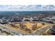 Aerial view of park with seating areas, walkways, and surrounding mixed-use buildings and neighborhood at 3862 Memphis Dr, Suwanee, GA 30024