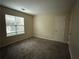 Neutral bedroom features cozy carpeting and natural light from a large window at 504 Harbor Lake Ct, Marietta, GA 30066