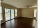 Bright bedroom with dark hardwood floors, ceiling fan, and sliding glass door to the deck at 504 Harbor Lake Ct, Marietta, GA 30066