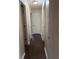 Hallway with dark wood floors and multiple white doors at 504 Harbor Lake Ct, Marietta, GA 30066