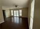 Cozy living room with dark wood flooring, ceiling fan, and a sliding glass door to the deck at 504 Harbor Lake Ct, Marietta, GA 30066