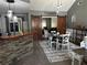 Open concept dining area with stone accent wall and sliding barn doors to the office space at 101 Flagler Way, Dallas, GA 30157