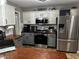 A spacious kitchen featuring modern appliances, stylish countertops, and ample room for cooking at 101 Flagler Way, Dallas, GA 30157