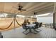 Covered back patio with ceiling fans, an outdoor dining set, and a hammock at 1445 Wheatfield Dr, Lawrenceville, GA 30043