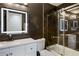 Modern bathroom features black marble style tile, lighted mirror, and glass shower at 1445 Wheatfield Dr, Lawrenceville, GA 30043