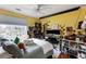 Cozy bedroom with a bright yellow accent wall and a large window at 1445 Wheatfield Dr, Lawrenceville, GA 30043