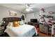 Comfortable bedroom features a tufted headboard, soft bedding and a ceiling fan at 1445 Wheatfield Dr, Lawrenceville, GA 30043