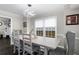 Bright dining area features modern lighting, gray walls, and large windows for natural light at 1445 Wheatfield Dr, Lawrenceville, GA 30043