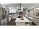 Spacious kitchen boasts white cabinets, stainless steel appliances, an island cooktop, and a seamless flow into the living area at 1445 Wheatfield Dr, Lawrenceville, GA 30043