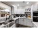 Stylish kitchen boasting white cabinetry, stainless steel appliances, and a modern design at 1445 Wheatfield Dr, Lawrenceville, GA 30043