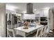 Modern kitchen featuring stainless steel appliances, a center island with seating, and white cabinetry at 1445 Wheatfield Dr, Lawrenceville, GA 30043
