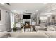 Comfortable living room featuring a fireplace, neutral decor, and an open layout connected to the dining area at 1445 Wheatfield Dr, Lawrenceville, GA 30043