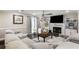 Bright and airy living room boasting modern decor, a cozy fireplace, and a large sectional sofa at 1445 Wheatfield Dr, Lawrenceville, GA 30043