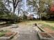 Large backyard with mature trees and a stone fireplace, perfect for gatherings at 2020 Wilandrew Dr, Decatur, GA 30033