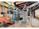 Full basement with exposed ductwork, painted support beams and steps at 2020 Wilandrew Dr, Decatur, GA 30033