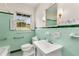 Vintage bathroom with mint green tile, a window, and traditional fixtures at 2020 Wilandrew Dr, Decatur, GA 30033