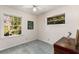 Bright bedroom featuring carpeted floors, two windows, and a ceiling fan at 2020 Wilandrew Dr, Decatur, GA 30033