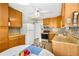 Functional kitchen with wood cabinets, vintage appliances, and a view from the window and adjacent dining area at 2020 Wilandrew Dr, Decatur, GA 30033