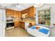 Cozy kitchen features wood cabinets, retro appliances, and a dining nook with a table and chairs at 2020 Wilandrew Dr, Decatur, GA 30033