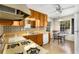 Functional kitchen with wood cabinets, vintage appliances, a view from the window, and an adjacent dining area at 2020 Wilandrew Dr, Decatur, GA 30033