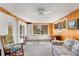 Bright living room with built-in storage, large windows, and a cozy seating area with a rocking chair at 2020 Wilandrew Dr, Decatur, GA 30033