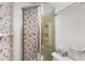 A glass door shower in the bathroom, featuring stylish patterned shower doors at 2020 Wilandrew Dr, Decatur, GA 30033