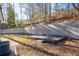 Backyard features a wood deck and concrete retaining wall at 2571 Hamill Dr, Buford, GA 30519