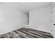 Finished basement with modern flooring, white walls, and a staircase at 2571 Hamill Dr, Buford, GA 30519