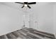 Spacious bedroom featuring a ceiling fan and modern gray toned wood flooring at 2571 Hamill Dr, Buford, GA 30519