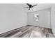 Bright bedroom features a ceiling fan and stylish gray wood-look flooring at 2571 Hamill Dr, Buford, GA 30519
