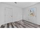 Bedroom has all-white paint with gray floors and a window for natural light at 2571 Hamill Dr, Buford, GA 30519