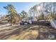 Home exterior featuring a spacious front yard, driveway, fence, and mature trees at 2571 Hamill Dr, Buford, GA 30519