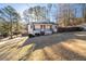 Charming home features a covered front porch, dark trim, manicured bushes, and a cozy curb appeal at 2571 Hamill Dr, Buford, GA 30519