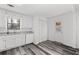 Bright eat-in kitchen with white cabinetry, modern countertops, and stainless dishwasher at 2571 Hamill Dr, Buford, GA 30519
