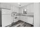Updated kitchen features ample white cabinets, and modern countertops at 2571 Hamill Dr, Buford, GA 30519