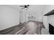 Bright living room boasts modern gray flooring, a ceiling fan, and an open floorplan leading to the kitchen at 2571 Hamill Dr, Buford, GA 30519