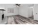 Well-lit living room featuring a fireplace, neutral paint, and updated flooring, creating a cozy atmosphere at 2571 Hamill Dr, Buford, GA 30519