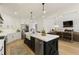 Spacious kitchen with white cabinets, a dark island, and stainless steel appliances, in an open-concept design at 1605 Ridge Haven Run, Alpharetta, GA 30022