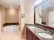 Bathroom featuring double sinks, granite counters, and a soaking tub at 2626 Peachtree Nw Rd # 1007, Atlanta, GA 30305