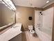 Clean bathroom with white fixtures, tub/shower, tile floor and a large mirror at 2626 Peachtree Nw Rd # 1007, Atlanta, GA 30305