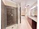 This bathroom features a glass walk-in shower, dual vanity sinks, a jacuzzi, and beige tile at 2626 Peachtree Nw Rd # 1007, Atlanta, GA 30305