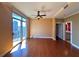 Bright living room featuring hardwood floors, a ceiling fan, and a sliding glass door to a balcony with city views at 2626 Peachtree Nw Rd # 1007, Atlanta, GA 30305