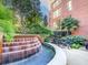 Beautiful water feature and terrace showcasing manicured landscaping and community seating at 2626 Peachtree Nw Rd # 1007, Atlanta, GA 30305