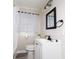 Updated bathroom with white vanity, modern fixtures, and a sleek black-framed mirror at 3490 Primrose Pl, Decatur, GA 30032