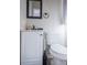 Modern bathroom featuring white vanity and toilet, with contrasting black mirror and faucet at 3490 Primrose Pl, Decatur, GA 30032