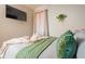 Bedroom featuring plush bedding, decorative pillows, a flat screen tv, and stylish curtains at 3490 Primrose Pl, Decatur, GA 30032